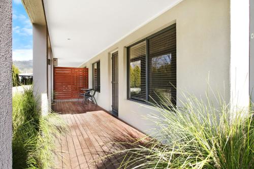 a porch of a house with a wooden deck at Grevillea Gardens Unit 8 in Bright