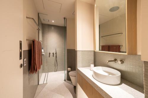 a bathroom with a toilet and a sink and a shower at Paragon in Sydney
