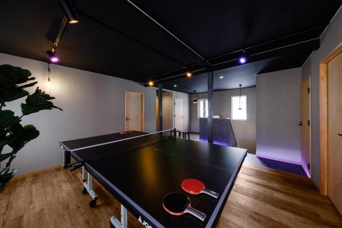 a ping pong table in the middle of a room at The Landmark in Furano