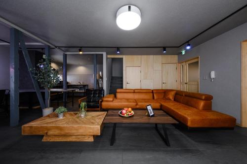 a living room with a couch and a table at The Landmark in Furano