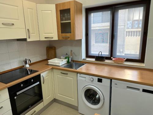 a kitchen with a sink and a washing machine at Ewa Apt - 3-Bedrooms Apt near Sliema - St Julians Seafront in Il-Gżira
