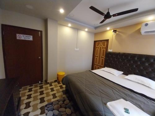 a bedroom with a bed and a ceiling fan at Le Luminous, Home Stay in Port Blair