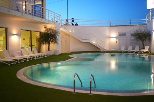 a swimming pool in the middle of a building at Hotel Majesty Alberobello in Alberobello