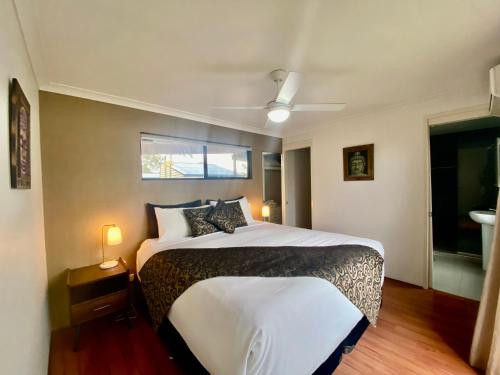 a bedroom with a bed and a window at Marcoola House, Pet Friendly, Sunshine Coast in Marcoola
