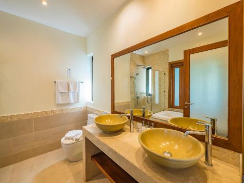 a bathroom with two sinks and a large mirror at Villa Vigo with gym and tennis court in Koh Samui