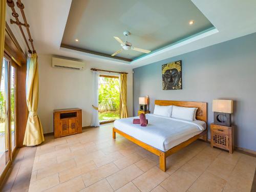 a bedroom with a bed and a television in it at Villa Vigo with gym and tennis court in Koh Samui