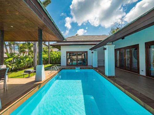 a swimming pool in the backyard of a villa at Villa Vigo with gym and tennis court in Koh Samui