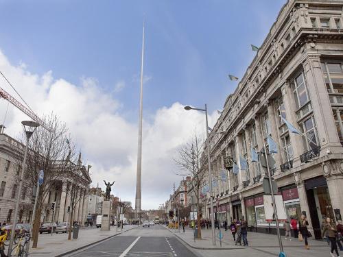 a city street with a tall obelisk in the distance at Arlington Hotel O'Connell Bridge in Dublin
