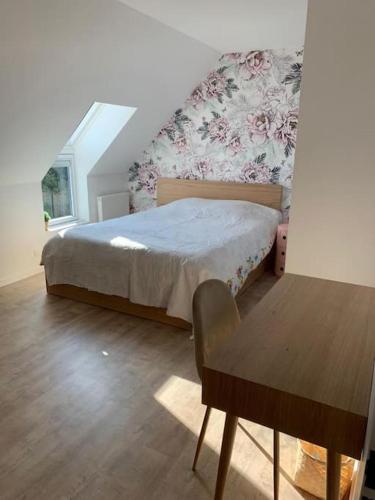 une chambre avec un lit et une table en bois dans l'établissement Maison idéalement située entre plages et commerces, à Carnac