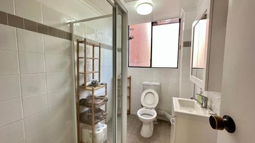 a bathroom with a toilet and a sink and a shower at Macquarie university and Metro nearby in Sydney
