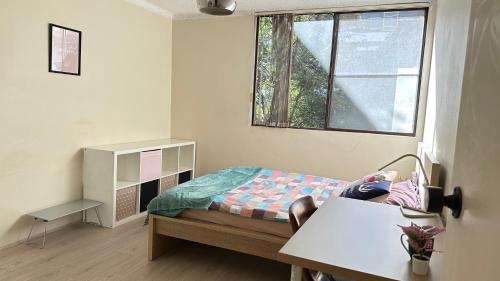 a small bedroom with a bed and a window at Macquarie university and Metro nearby in Sydney