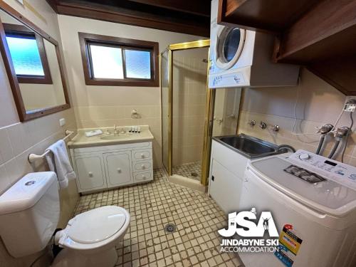 a bathroom with a toilet and a sink and a shower at Cedar Haven in Jindabyne