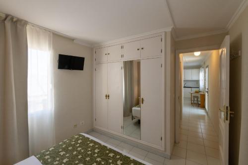 a bedroom with a mirror and a bed in a room at Hotel Marte in Puerto de la Cruz