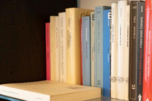 a row of books sitting on a shelf at RipassoQui in Custoza