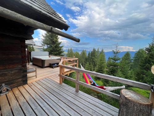 a deck with a couch and a hammock on it at Almhütte Kärnten in Maltaberg