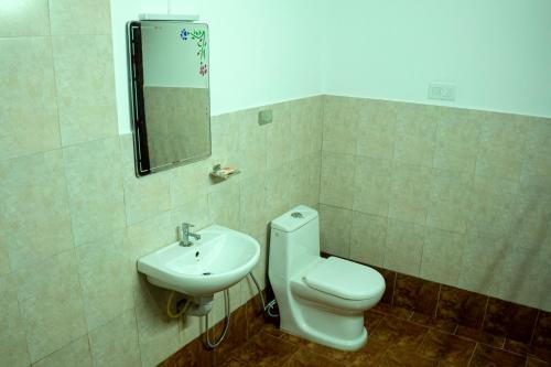 a bathroom with a toilet and a sink at The Nest Thattekad in Thattakād