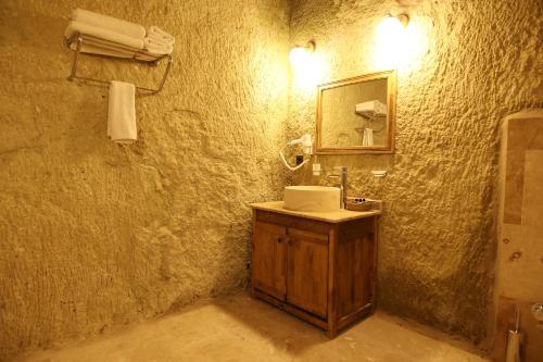 a bathroom with a sink and a mirror at Cappadocia Vita Cave Hotel in Urgup