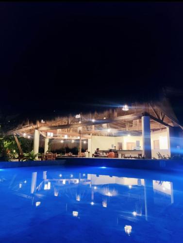 a view of a swimming pool at night at Tropical Bungalows-Siargao in General Luna