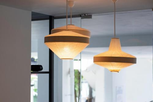 three lights hanging from the ceiling in a room at Harbour Ville Hotel in Singapore