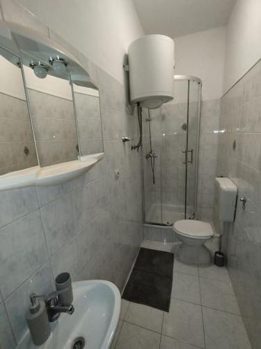a bathroom with a shower and a sink and a toilet at Apartment Bella Costa II. in Kaštela