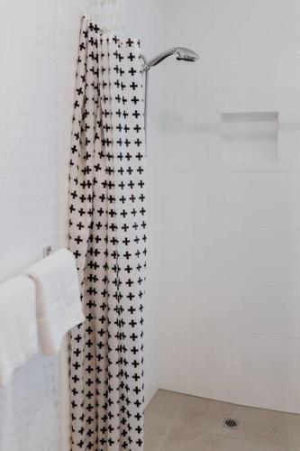a bathroom with a shower curtain and a towel at Cedar House ~ Family Fun! in Bicheno