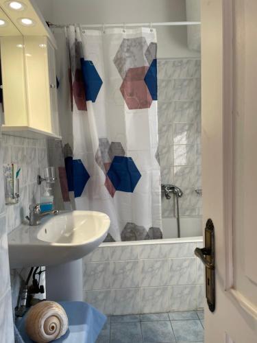 a bathroom with a sink and a shower at The Great Balcony in Ioulis