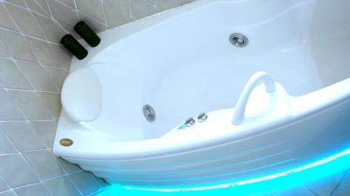 a bathroom with a white bath tub with a toilet at LUX-Porto Cervo Center Sea View Apartment in Porto Cervo