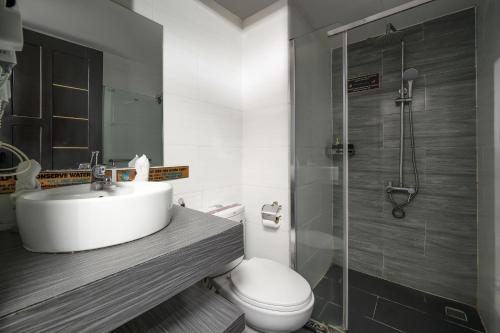 a bathroom with a sink and a toilet and a shower at Hanami Hotel Danang in Da Nang