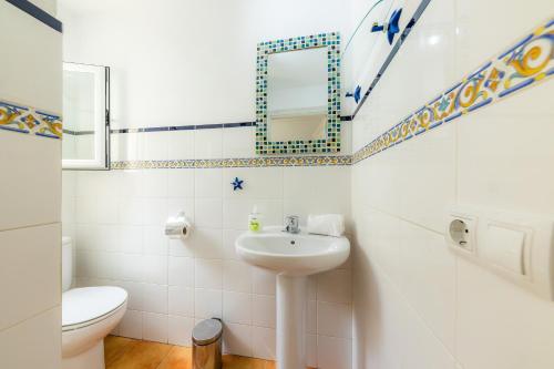 a bathroom with a sink and a toilet at Casa Jaume A in Artá
