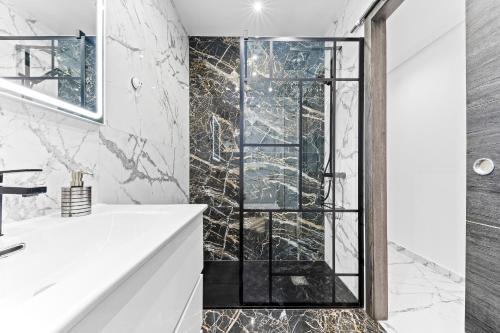 a bathroom with a shower with a glass door at Apolo beach front - sea view luxury apartment in Torrevieja