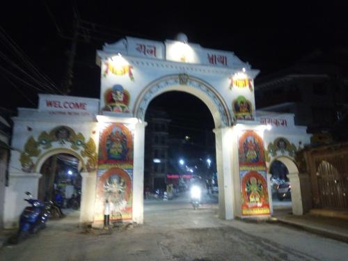 an archway with a motorcycle parked in front of it at night at TARA ART HOUSE in Pātan