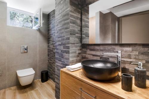 a bathroom with a black bowl sink on a counter at Polys Villa Lefkada 1 in Lefkada Town