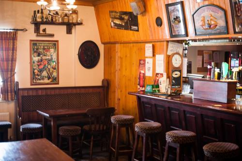 a bar in a restaurant with stools at Slieve League Lodge in Carrick