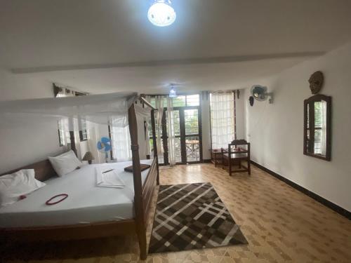1 dormitorio con 1 cama y sala de estar en Kingstone lodge zanzibar, en Bet-el-Mali
