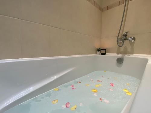 a bath tub filled with lots of colorful pet rocks at Apartment in Bansko, very close to the Gondola in Bansko