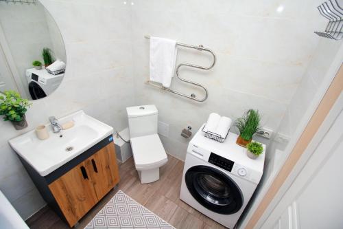 a bathroom with a washing machine and a sink at Уютная студия в ЖК Шахар возле ТРЦ Asia Park! in Almaty