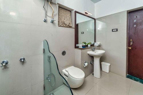 a bathroom with a toilet and a sink and a shower at YAAN Udaipur in Udaipur