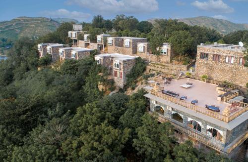 an aerial view of a mansion in the mountains at YAAN Udaipur in Udaipur