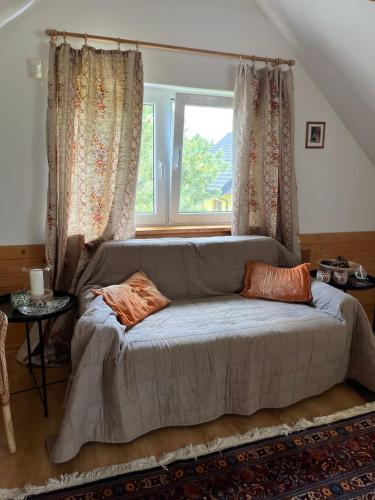 a large bed in a room with a window at Domek Radość in Cieksyn