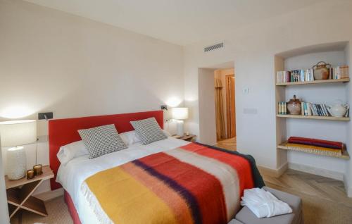 a bedroom with a large bed with a colorful blanket at La Dehesa de Don Pedro in Monesterio