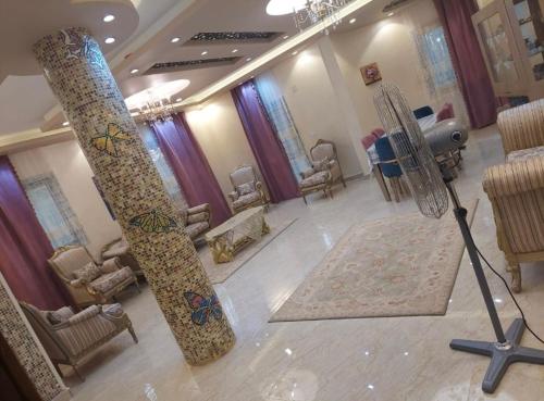 a room with two snowboards on the floor and chairs at فيلا لوزان الريف الاوروبي in ‘Ezbet Sharikât Wardan