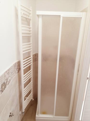 a walk in closet with a glass door at La Casera in Lido di Dante