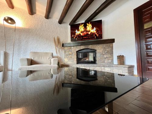 a fireplace in a living room with a fire place at Cal Poldo in Marganell