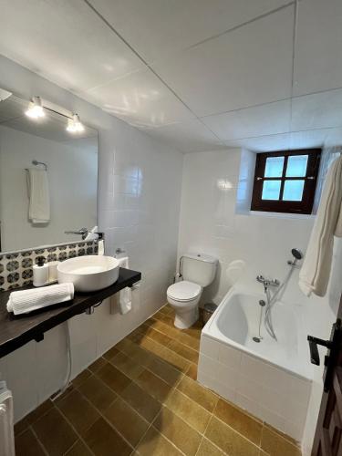 a bathroom with a sink and a tub and a toilet at Cal Poldo in Marganell