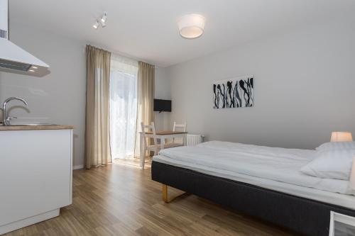 En eller flere senge i et værelse på Liepų apartamentai