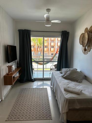 a bedroom with a bed and a large window at VG FUN 308 Praia do Futuro in Fortaleza