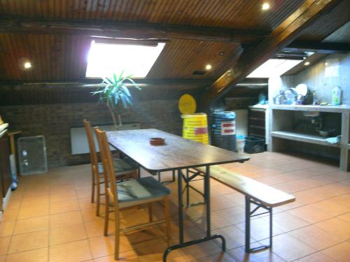 a small kitchen with a table and chairs at Hostel California in Milan