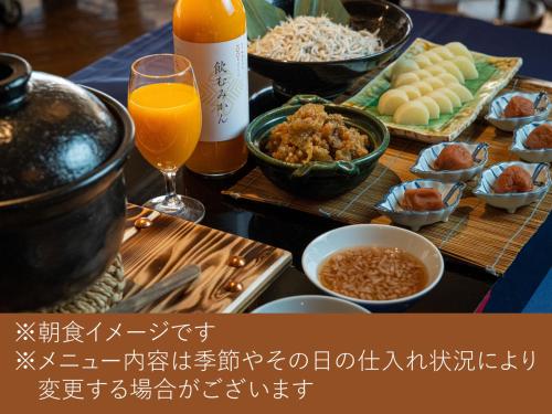 a table full of food and drinks and a table with food at Hotel Granvia Wakayama in Wakayama