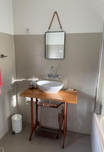 a bathroom with a white sink and a mirror at Casa do Moura in Arcos de Valdevez