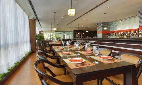 a dining room with a long table and chairs at Eurobuilding Hotel & Suites Caracas in Caracas